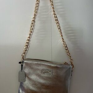 100% leather handbag with removable gold chain strap and clip on wristlet strap.